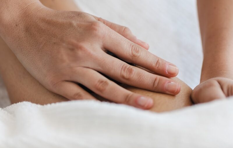 a close up of a person laying in a bed with a towel